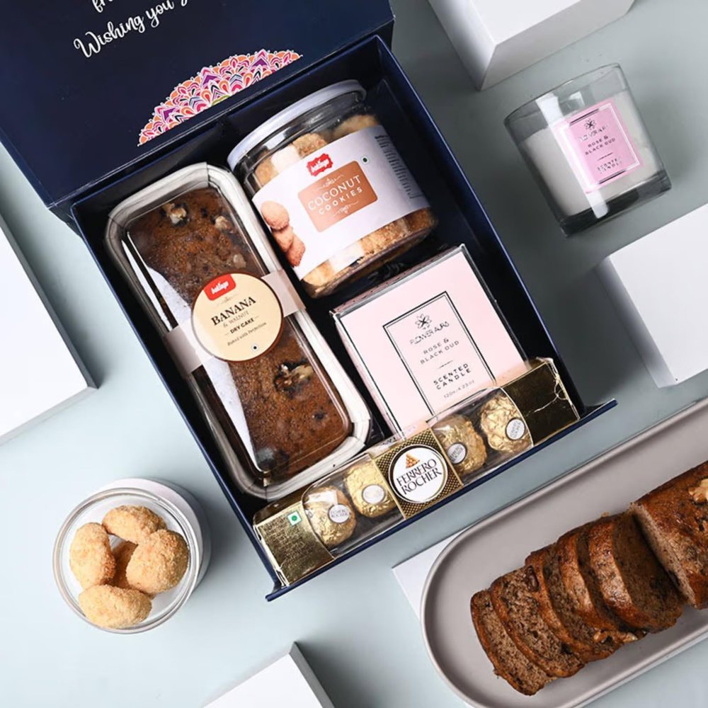 FlowerAura Premium Gift Hamper of Tea Cake, Cookies, Scented Candle & 4 Choco Balls Gift For Birthday | Anniversary | Love | Girlfriend's Day | Mothers Day Gift For Mom (Same Day Delivery)