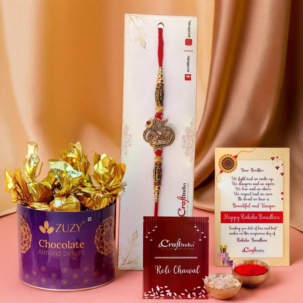 eCraftIndia Golden Lord Ganesha Om Designer Rakhi for Brother with Chocolate, Zuzy Almond Chocolate Box, Rakhi with Chocolate Gift - Roli Chawal Pack, Raksha Bandhan Greeting Card
