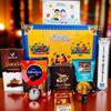 SOULWARE Rakhi Gift Combo Box for Brother Bhaiya & Bhabhi-9 Inclusions + Evil Eye Rakhi Nazar Kavach|Chocolate,Millet Namkeen,Almond Bar,Incense Sticks & Stand,Perfume,Coin,Card,Roli Chawall view 1