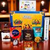 MOBINA Rakhi Gift Combo Box for Brother Bhaiya & Bhabhi-9 Inclusions + Evil Eye Rakhi Nazar Kavach|Chocolate,Millet Namkeen,Almond Bar,Incense Sticks & Stand,Perfume,Coin,Card,Roli Chawall view 1