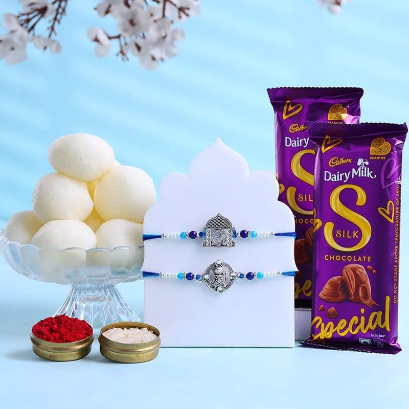 FlowerAura Premium Rakhi For Brother Combo Include Set of 2 Om & Krishna Rakhi With 1Kg Rasgulla, 2 Chocolates & Roli Chawal Set - Rakhi Gift For Brother, Bhai, Cousin, Kid (Same Day Delivery)